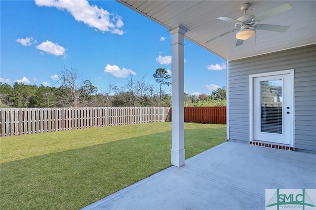 view of yard featuring a fenced backyard, ceiling fan, and a patio