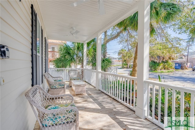 balcony with a porch and a ceiling fan