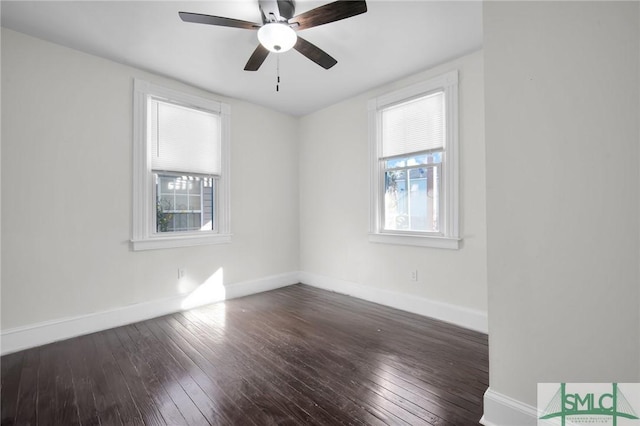 spare room featuring plenty of natural light, baseboards, and hardwood / wood-style floors