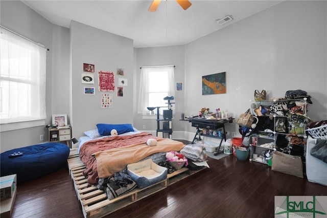 bedroom with wood-type flooring, visible vents, and a ceiling fan