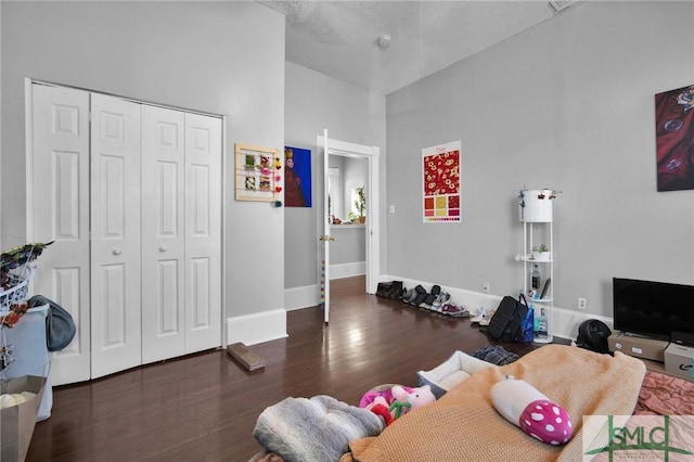 interior space featuring a closet, wood finished floors, and baseboards