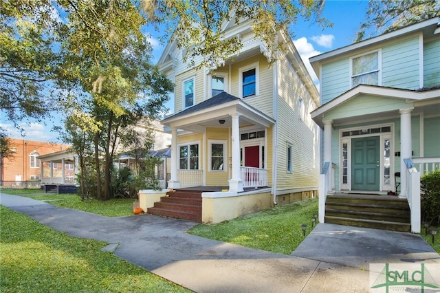 view of front of home with a porch and a front yard