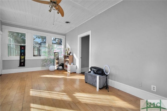 sitting room featuring hardwood / wood-style floors, a ceiling fan, and baseboards