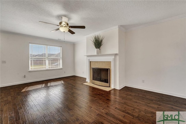 unfurnished living room with hardwood / wood-style flooring, a fireplace with flush hearth, a ceiling fan, baseboards, and crown molding