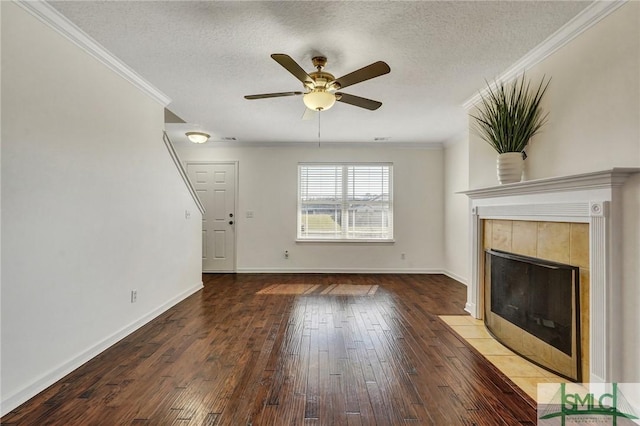 unfurnished living room with a textured ceiling, wood-type flooring, and crown molding