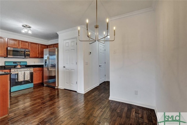 kitchen featuring ornamental molding, appliances with stainless steel finishes, dark wood-style flooring, and dark countertops