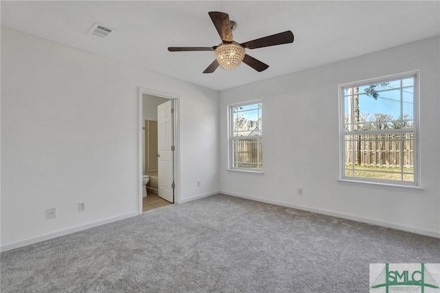 unfurnished bedroom with carpet floors, visible vents, baseboards, and a ceiling fan