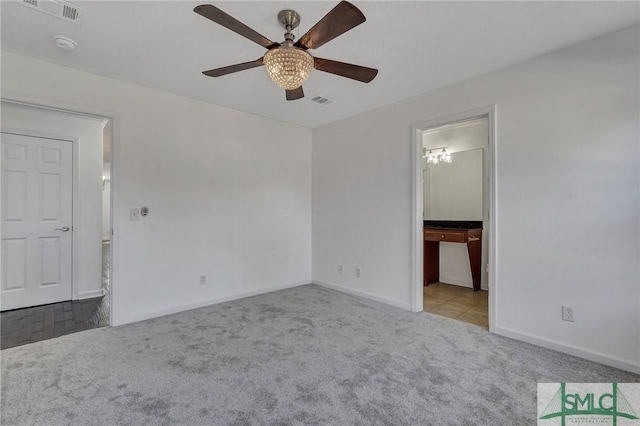 unfurnished bedroom with carpet floors, visible vents, baseboards, and a ceiling fan