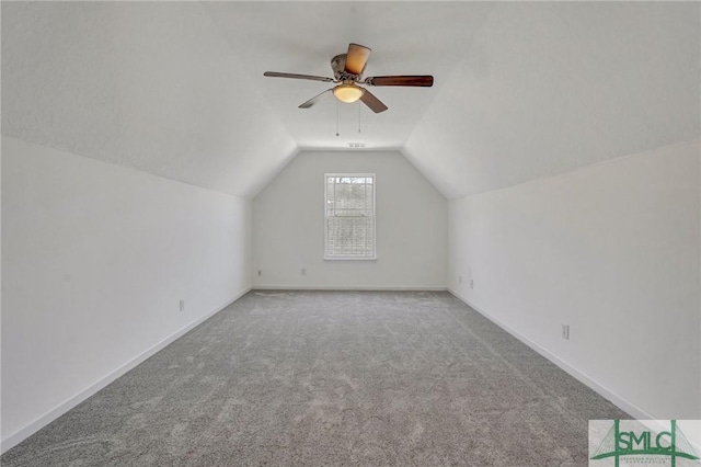 bonus room with lofted ceiling, baseboards, carpet floors, and ceiling fan