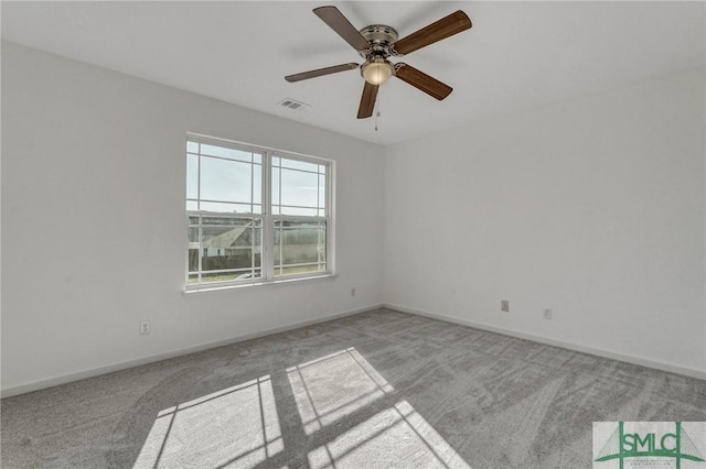 spare room with a ceiling fan, carpet, visible vents, and baseboards