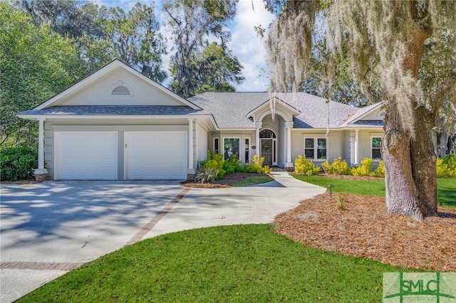 ranch-style house with driveway, roof with shingles, a front lawn, and a garage