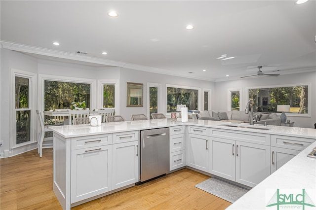kitchen with recessed lighting, ornamental molding, dishwasher, and a sink
