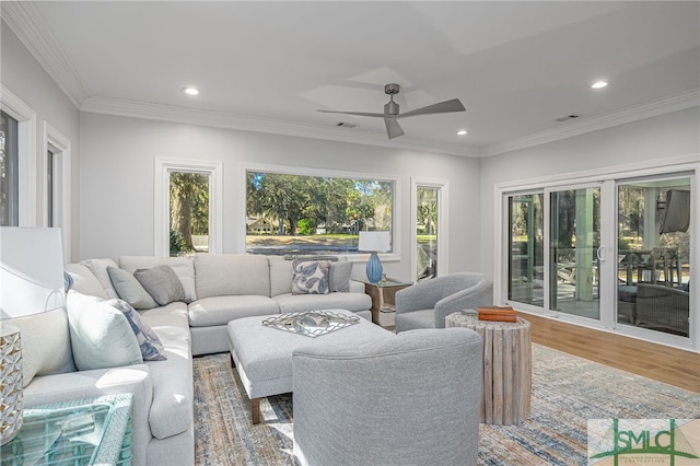 living room with wood finished floors, ceiling fan, recessed lighting, and ornamental molding