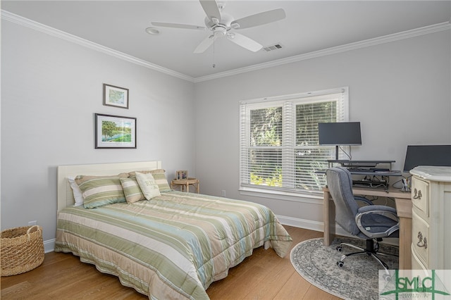 bedroom featuring baseboards, ornamental molding, ceiling fan, and wood finished floors