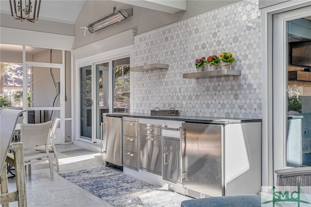 kitchen featuring open shelves, a chandelier, dark countertops, freestanding refrigerator, and refrigerator