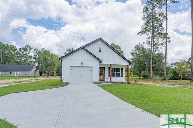 modern inspired farmhouse featuring a garage, a front yard, concrete driveway, and covered porch