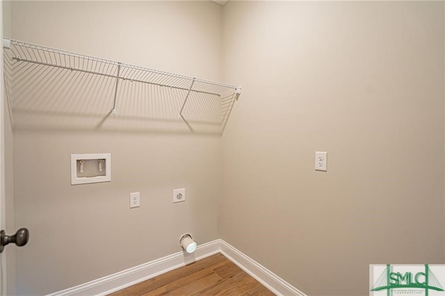 washroom with laundry area, baseboards, wood finished floors, hookup for a washing machine, and hookup for an electric dryer