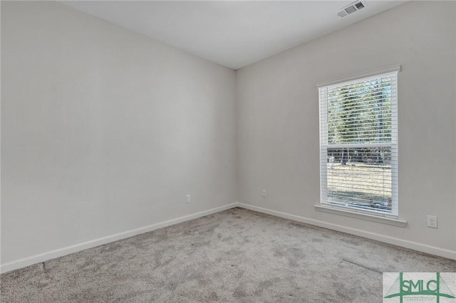 spare room with baseboards, visible vents, and carpet floors