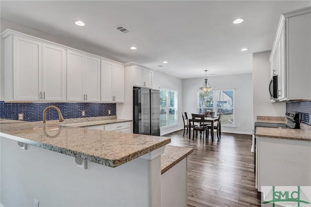 kitchen featuring dark wood finished floors, white cabinetry, and appliances with stainless steel finishes