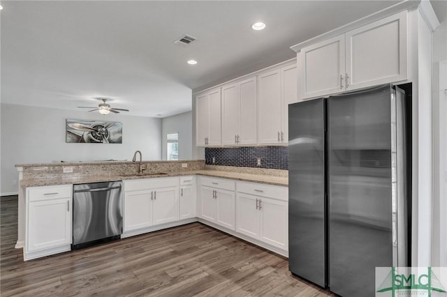 kitchen featuring a sink, visible vents, white cabinetry, and stainless steel appliances