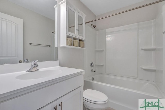 bathroom featuring toilet,  shower combination, and vanity