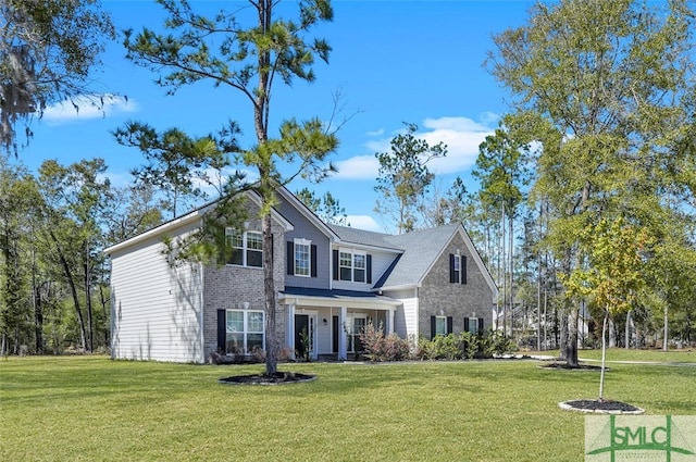 traditional home featuring a front lawn and brick siding