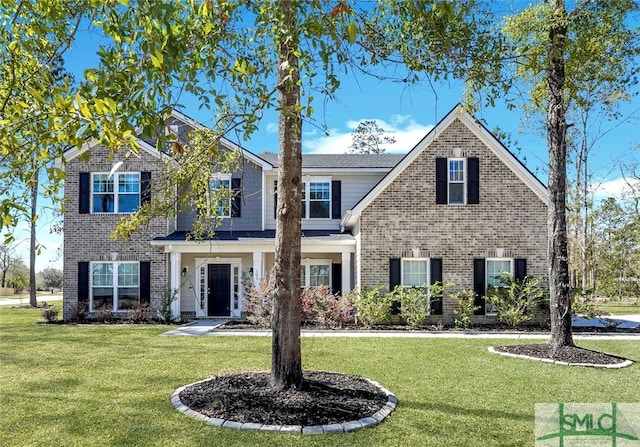 view of front of home with brick siding and a front lawn