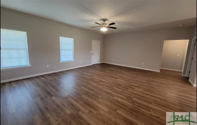 interior space featuring ceiling fan, baseboards, and dark wood finished floors