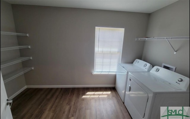 clothes washing area with laundry area, baseboards, wood finished floors, and independent washer and dryer