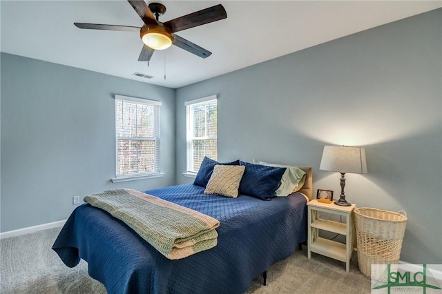 bedroom featuring ceiling fan, carpet flooring, visible vents, and baseboards