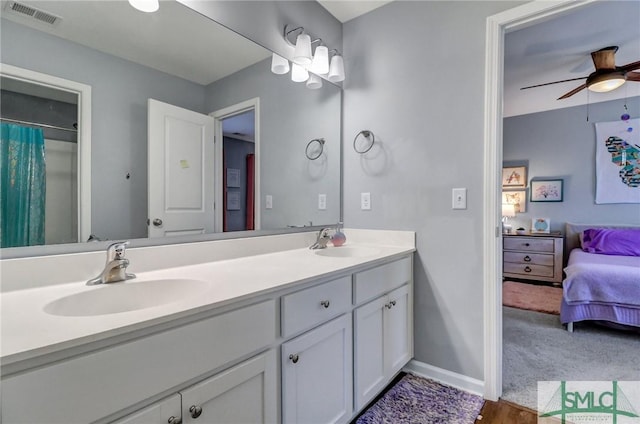 full bathroom featuring visible vents, a sink, baseboards, and double vanity