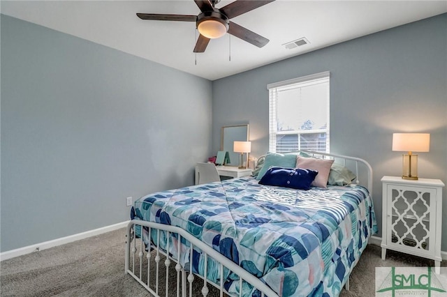 carpeted bedroom with a ceiling fan, visible vents, and baseboards