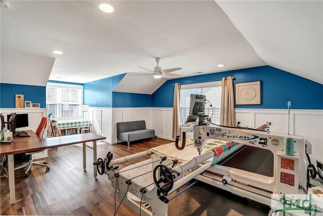 exercise room with vaulted ceiling, a wainscoted wall, wood finished floors, and a ceiling fan