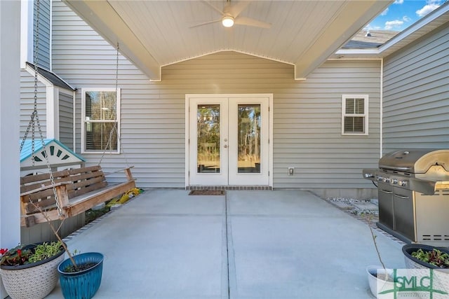 entrance to property with ceiling fan, a patio, and french doors