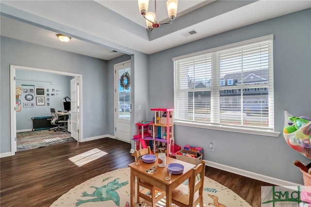 rec room with a notable chandelier, visible vents, baseboards, and wood finished floors