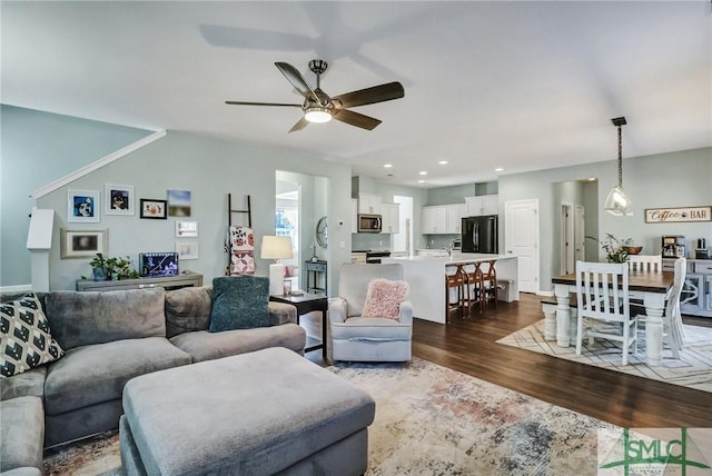 living area with dark wood finished floors, a ceiling fan, and recessed lighting