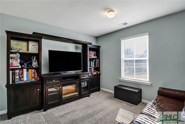 carpeted living room with visible vents and baseboards