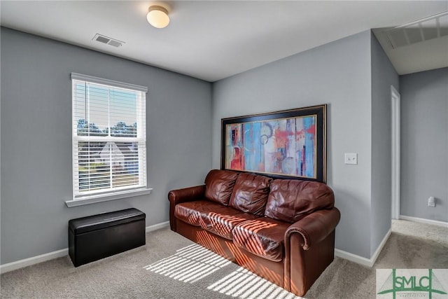 living area featuring carpet, baseboards, and visible vents