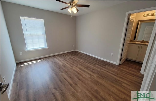 unfurnished bedroom featuring ceiling fan, dark wood-type flooring, and baseboards