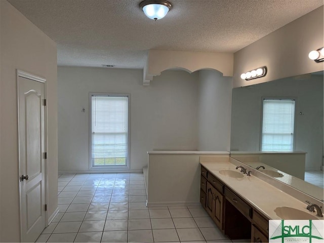 bathroom with double vanity, a sink, and tile patterned floors