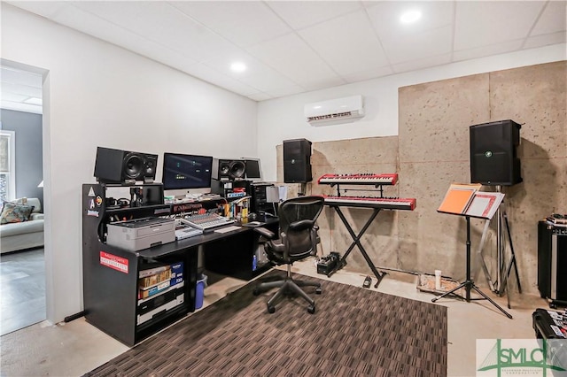 office space featuring concrete flooring, a drop ceiling, and a wall mounted AC