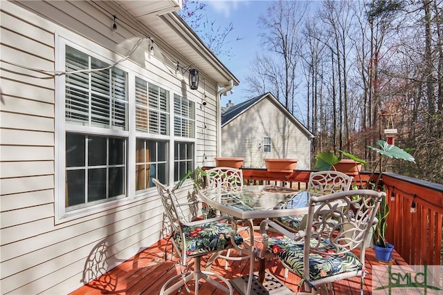 wooden deck featuring outdoor dining space