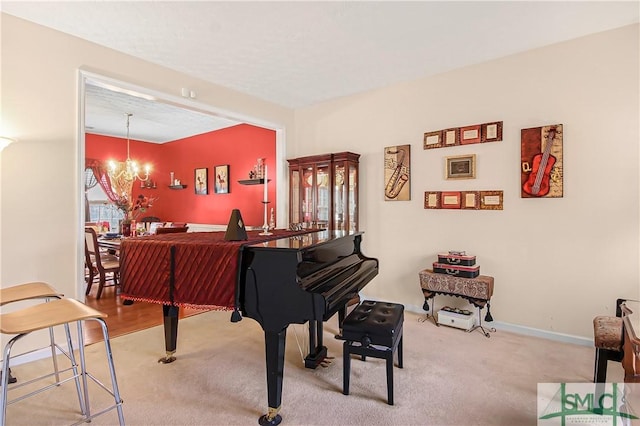 sitting room with carpet, a chandelier, and baseboards