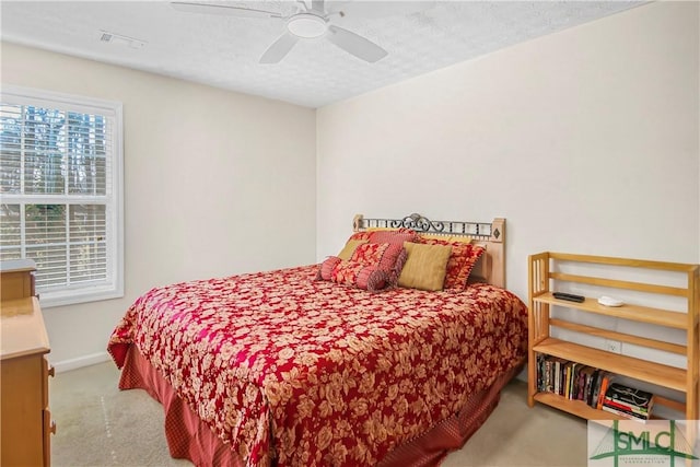 bedroom with baseboards, visible vents, a ceiling fan, a textured ceiling, and carpet flooring