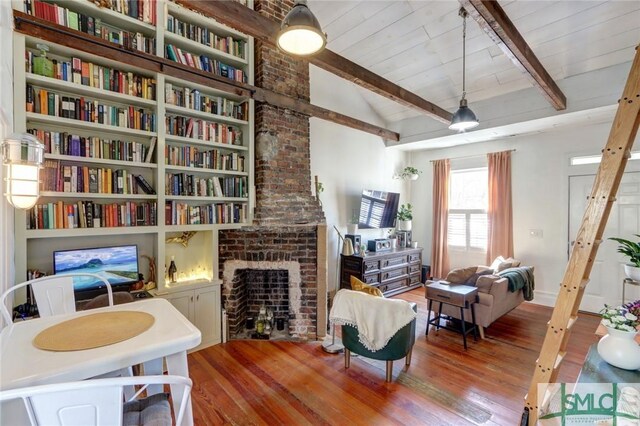 living area featuring vaulted ceiling with beams, wood ceiling, a fireplace, and wood finished floors