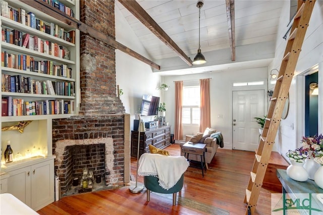 living room featuring wood ceiling, a brick fireplace, vaulted ceiling with beams, and wood finished floors