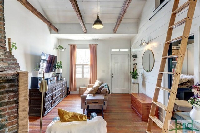 living room featuring wood finished floors and beam ceiling