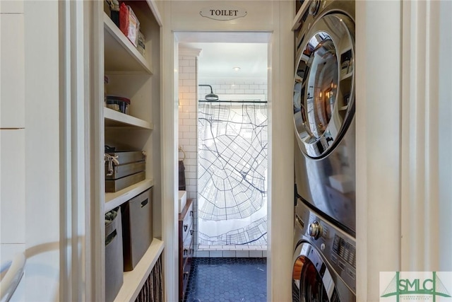 washroom with stacked washer and dryer and laundry area