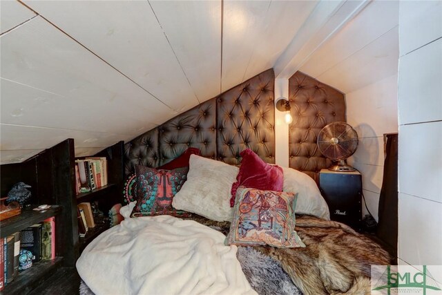 bedroom featuring vaulted ceiling with beams