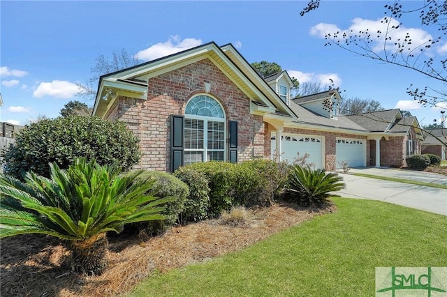 view of front of property featuring a garage, a front yard, concrete driveway, and brick siding